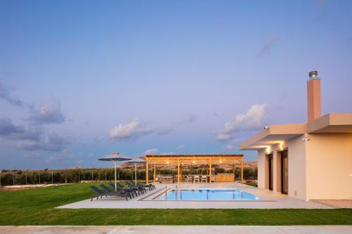 a pool in the backyard of a house at Villa Red Sunset by Estia in Sfakaki