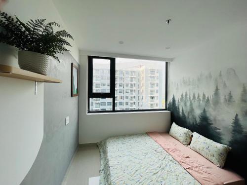 a bedroom with a bed and a large window at Nera home, An apartment Huế in Thôn Văn Dương