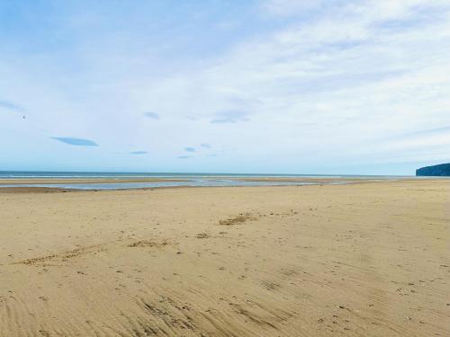 an empty beach with footprints in the sand at Beach Retreat in Filey
