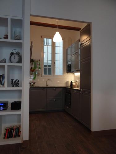 a kitchen with stainless steel appliances and a window at Valencia what else... in Valencia