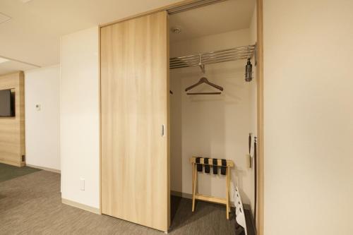 a closet with a sliding door in a room at Richmond Hotel Tenjin Nishi-Dori in Fukuoka