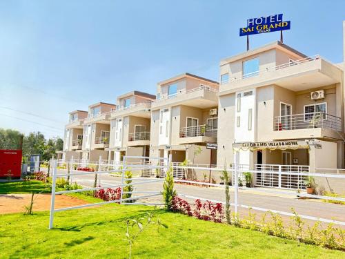 a large apartment building with a sign that reads hotel subway grand at Sai Grand Villa Hotel Near Bangalore Airport in Bengaluru