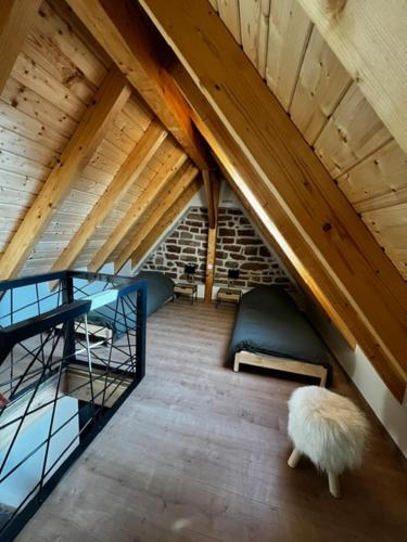 a attic room with a couch and a sheep in it at Grange Des Rêves in Lichtenberg