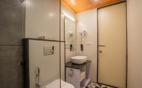 a bathroom with a shower and a toilet and a sink at Perfectstayz Premium Westend at Mall Road in Mussoorie