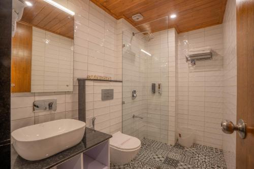 a white bathroom with a sink and a toilet at Perfectstayz Premium Westend at Mall Road in Mussoorie
