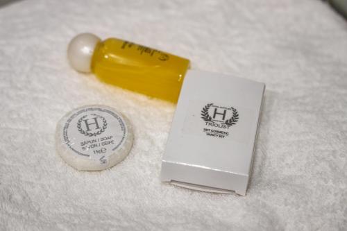 a close up of a lighter and a bottle of lipstick at Royal Boulevard Residence in Chişinău