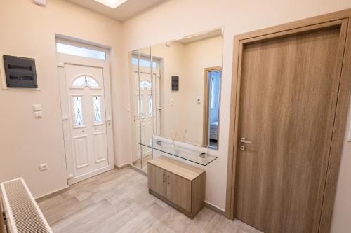 a bathroom with a sink and a mirror at Aurum Residence in Volos