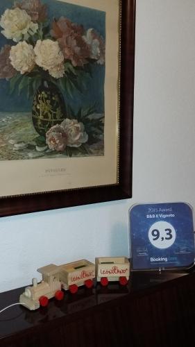 a toy train on a table next to a painting at B&B Il Vigneto in Melano
