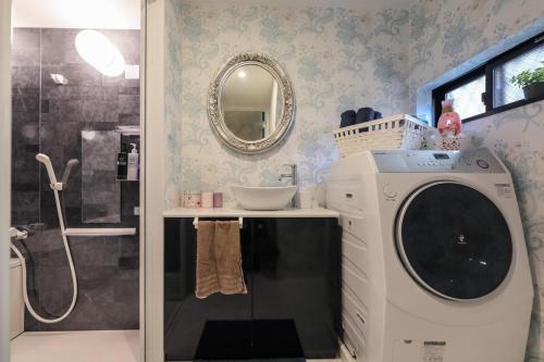 un bagno con lavatrice e lavandino di 大阪城そばにある一軒家 ad Osaka