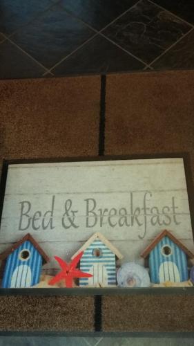 a cake with the words bed and breakfast on it at B&B Il Vigneto in Melano