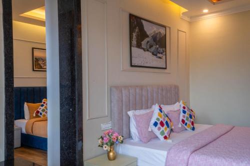 a bedroom with a bed with pillows on it at Perfectstayz Premium Westend at Mall Road in Mussoorie