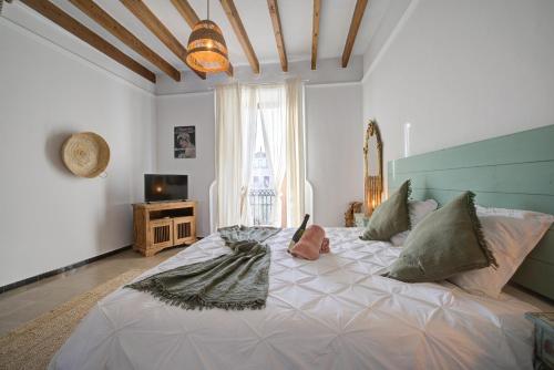 a bedroom with a large bed with pillows on it at Hotelet Can Oms Chopin by Rentallorca in Petra