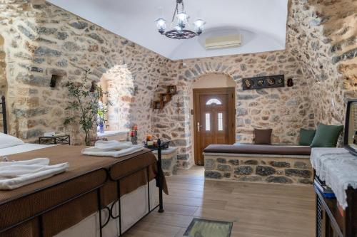 a bathroom with stone walls and a sink and a tub at Stratis Tower since 1892 in Oítilon