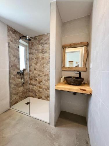 a bathroom with a shower with a sink and a mirror at CORRALEJO SURF HOUSE & SCHOOL only SURF in Corralejo