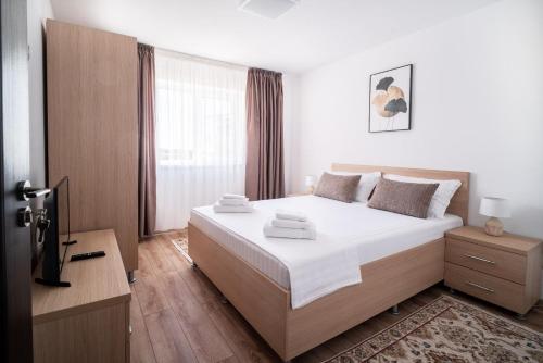 Postel nebo postele na pokoji v ubytování Nice & Cozy Sulina