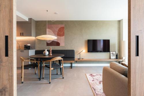 a living room with a table and a kitchen at BizStay Walden in The Hague