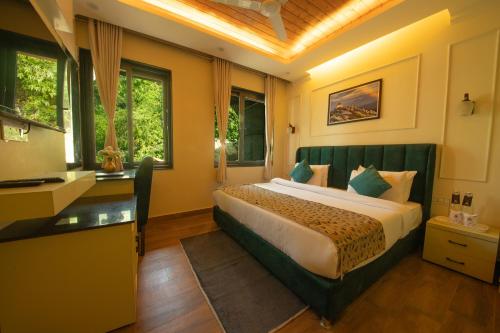 a hotel room with a bed and a desk at Perfectstayz Premium Westend at Mall Road in Mussoorie