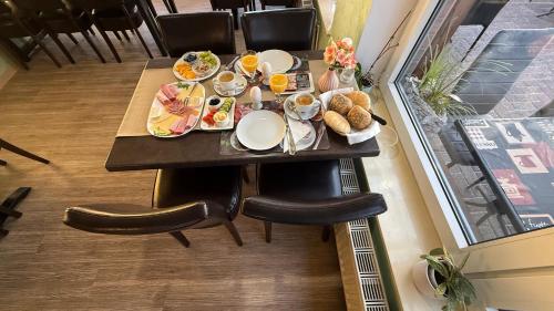a table with plates of food on top of it at Pension Restaurant Pizzeria Lion in Krummhörn
