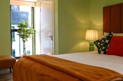 a bedroom with a large bed and a window at Sunday Street Boutique in Drogheda