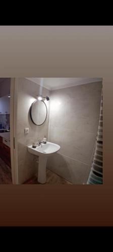 a bathroom with a white sink and a mirror at DREAM ROOMs in Nea Kallikrateia