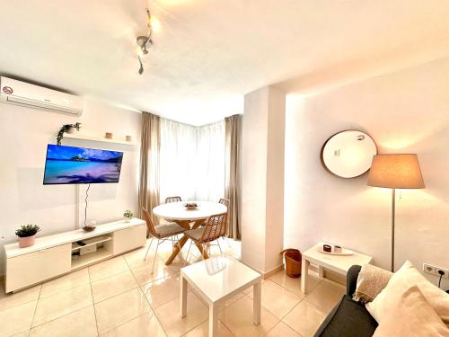 a living room with a couch and a table at Apartamentos J&K in Torremolinos