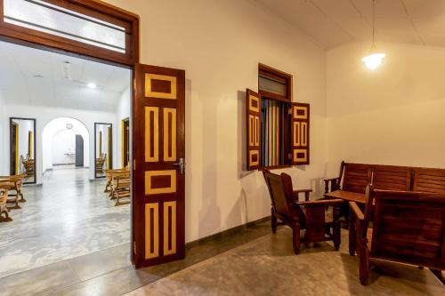 a room with a door and a table and chairs at Pleasure Villa in Matara