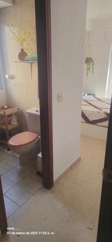 a bathroom with a toilet and a bed at habitacion Playa Levante in Benidorm