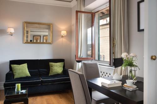 a living room with a couch and a table at Tornabuoni Suites Collection Residenza D'Epoca in Florence