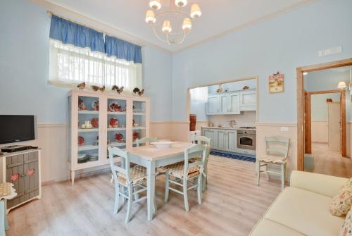 a kitchen and dining room with a table and chairs at La Bouganville Holiday House in Agropoli