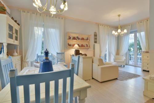 a living room with a table and chairs and a dining room at La Bouganville Holiday House in Agropoli