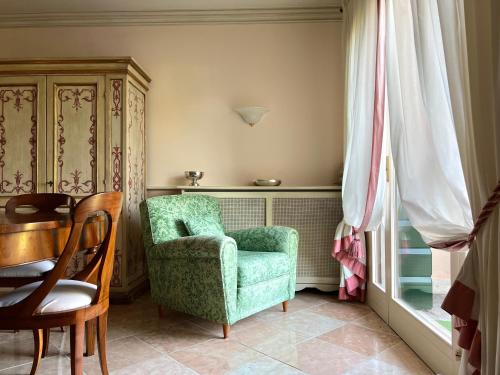 a living room with a chair and a table at Terme Colli Golf - Suite La Montecchia in Montecchia