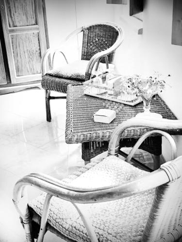 a room with two chairs and a table and a tableablish at BnB Inn - Cyclists & Bikers - CAMERE CON BAGNO PRIVATO-PARCHEGGIO INTERNO PER MOTO e BICI -ENERGETIC BREAKFAST extra in Làconi