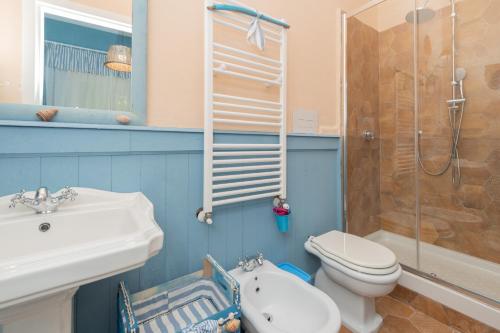 a bathroom with a sink and a toilet and a shower at La Bouganville Holiday House in Agropoli