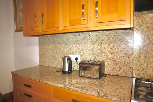 a kitchen with a counter top with a toaster and a toasterrences at The Church E in Manchester