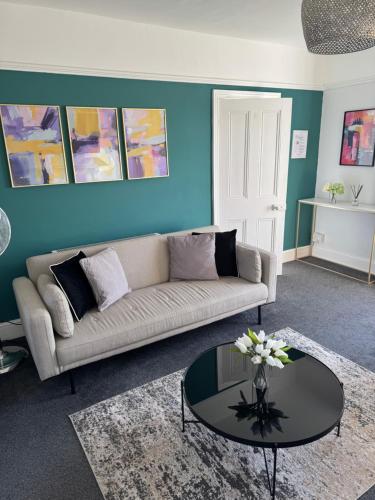 a living room with a couch and a table at Stylish One Bedroom Apartment in Norwich
