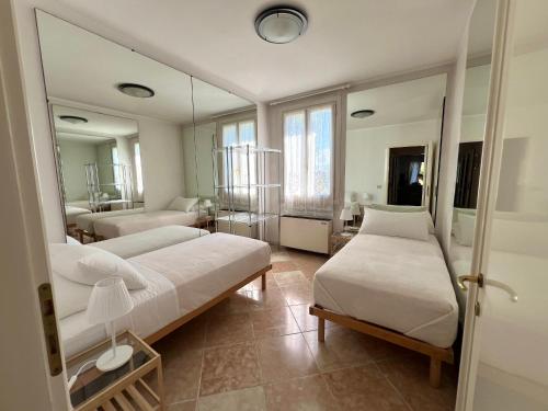 a bedroom with two beds and a mirror at Terme Colli Golf - Suite La Montecchia in Montecchia