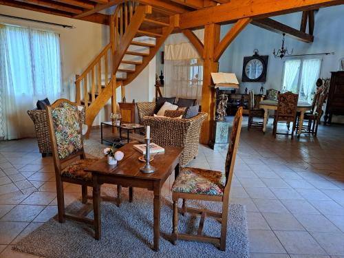 a living room with a wooden table and chairs at La Barde Montfort, votre maison d'hôtes à 4 kms de Sarlat Dordogne in Vitrac