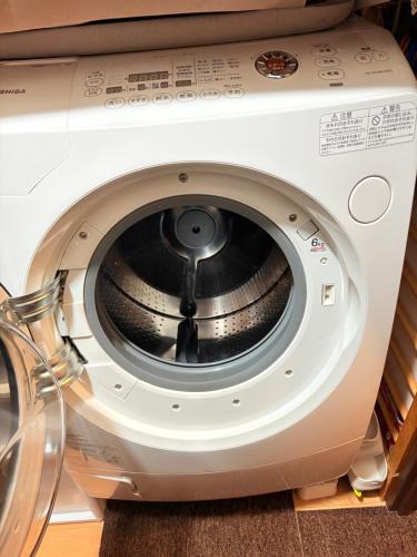 a washing machine is sitting on a shelf at hostel sunflower201 in Osaka