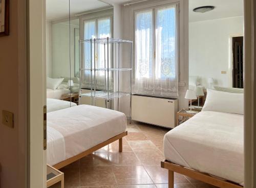 a bedroom with two beds and a mirror at Terme Colli Golf - Suite La Montecchia in Montecchia