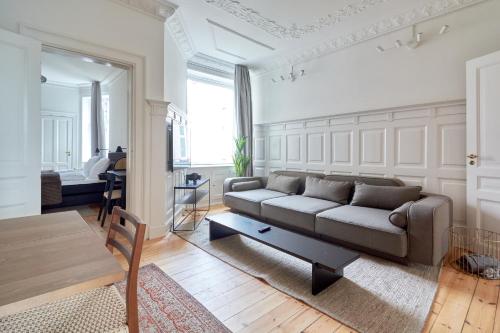 a living room with a couch and a table at 2BR Loft - Modern & Central in Copenhagen