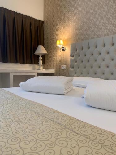a bedroom with a large bed with a large headboard at Nuova Opera Rooms in Verona