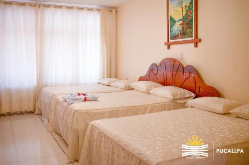 Ένα ή περισσότερα κρεβάτια σε δωμάτιο στο Hotel Sol del Oriente Pucallpa