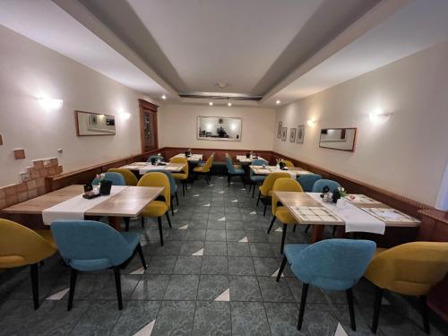a row of tables and chairs in a restaurant at Hotel MANTOVA Vrhnika in Vrhnika