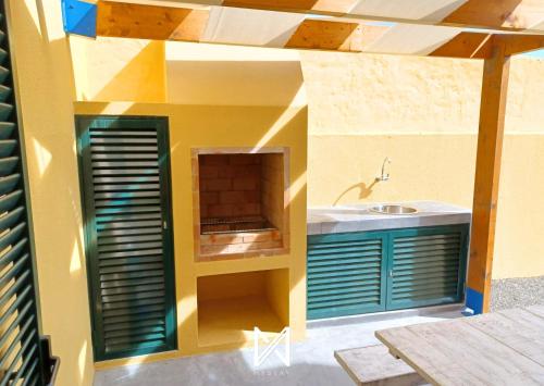 a lego house with a kitchen and a sink at MyStay - Porto Santo apartment near the beach in Porto Santo