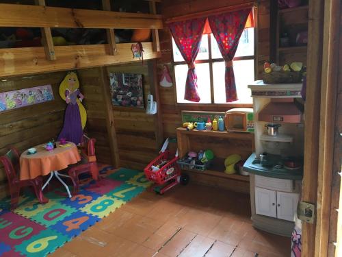 a toy kitchen with a table in a room at Casa d'Campo Tababela Hotel Boutique in Tababela