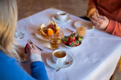 a woman sitting at a table with a plate of food at Podere Cerciano in Radicondoli