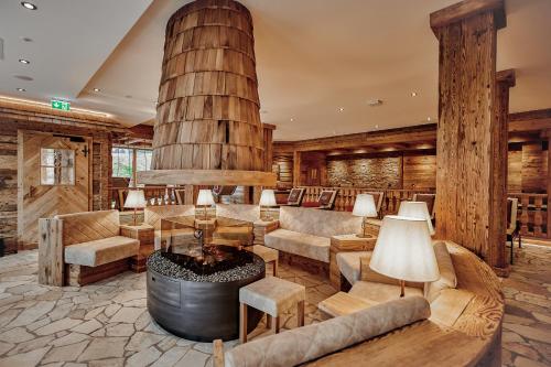 a lobby with a large room with a fireplace and furniture at Wellness & Naturhotel Tonihof in Langdorf im Landkreis Regen