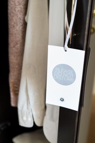 a white bag hanging on a closet door at Tornabuoni Suites Collection Residenza D'Epoca in Florence