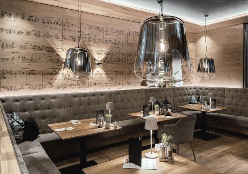 a restaurant with two tables and a wall with music at Wellness & Naturhotel Tonihof in Langdorf im Landkreis Regen
