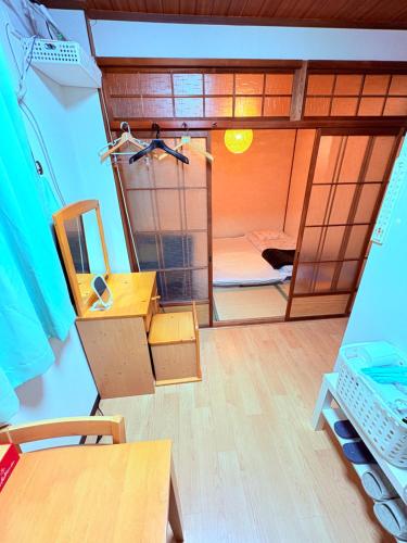a small room with a bunk bed and a mirror at hostel sunflower201 in Osaka